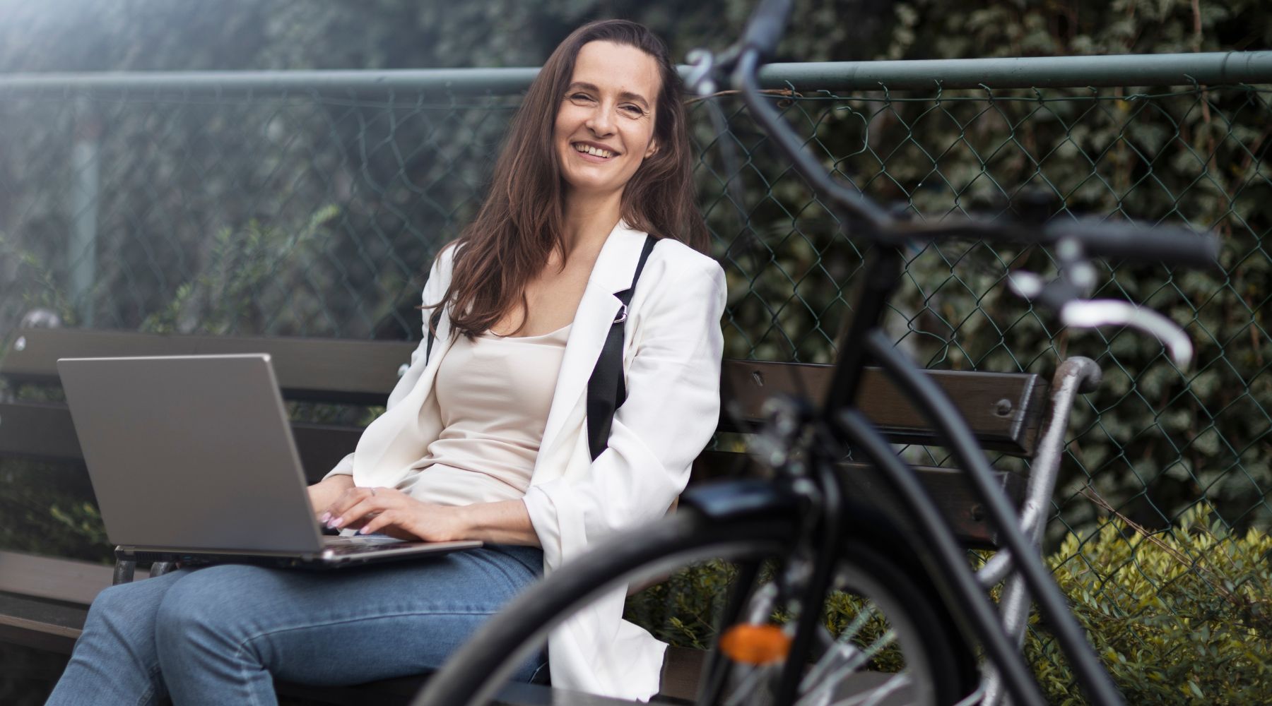 woman on a wheelchair choosing the right wheelchair on her laptop while smiling