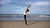 person stretching in the beach to be on top of their health and wellness