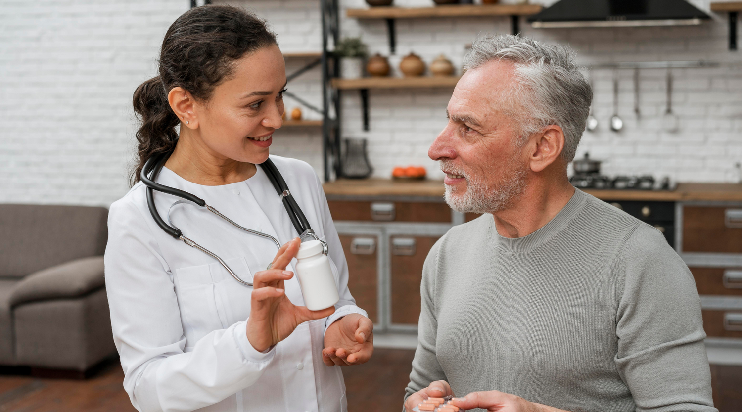 doctor showing older man a bottle of pills
