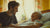 person bonding with a bedridden elder smiling