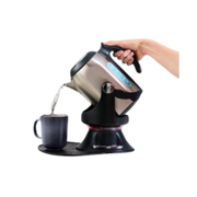 A hand operating the ADL Kitchen Gilia Cordless Kettle Tipper in silver and black, safely tipping a stainless steel kettle to pour hot water into a mug without lifting.