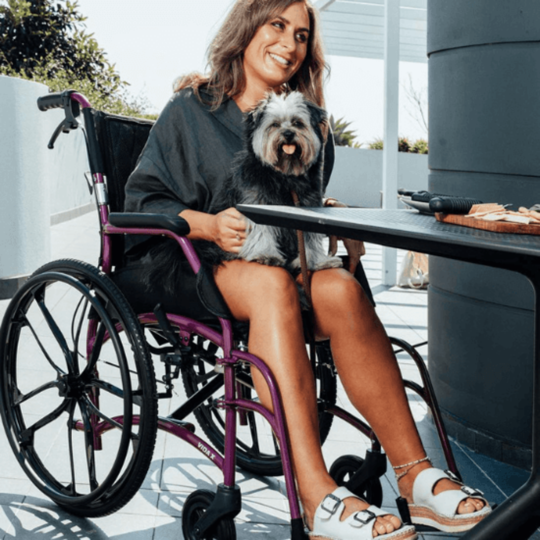 Aspire VIDA X Folding Wheelchair with adjustable armrests, swing-away leg rests, and large self-propelling rear wheels in a charcoal aluminium frame.
