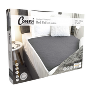 Packaging of Conni Bed Pad with Tuck-ins in charcoal color displayed in a home setting, indicating the product is for incontinence use.