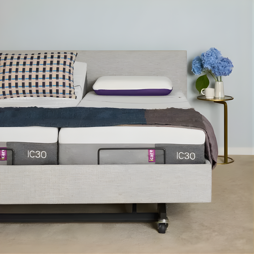 Icare IC333 Homecare Bed shown with adjustable backrest and leg rest, featuring upholstered finish and ultra-low height for safe mobility.