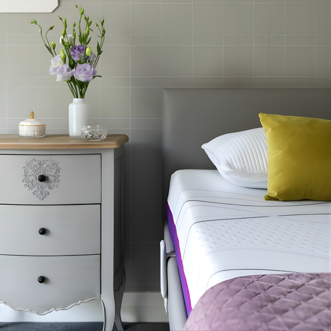 Icare IC333 Homecare Bed shown with adjustable backrest and leg rest, featuring upholstered finish and ultra-low height for safe mobility.