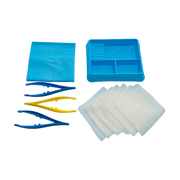 Unpacked Multigate Basic Dressing Pack showing a blue plastic compartment tray, folded blue sterile field drape, two blue plastic forceps, one yellow plastic forceps, and a stack of white non-woven swabs on a transparent background.