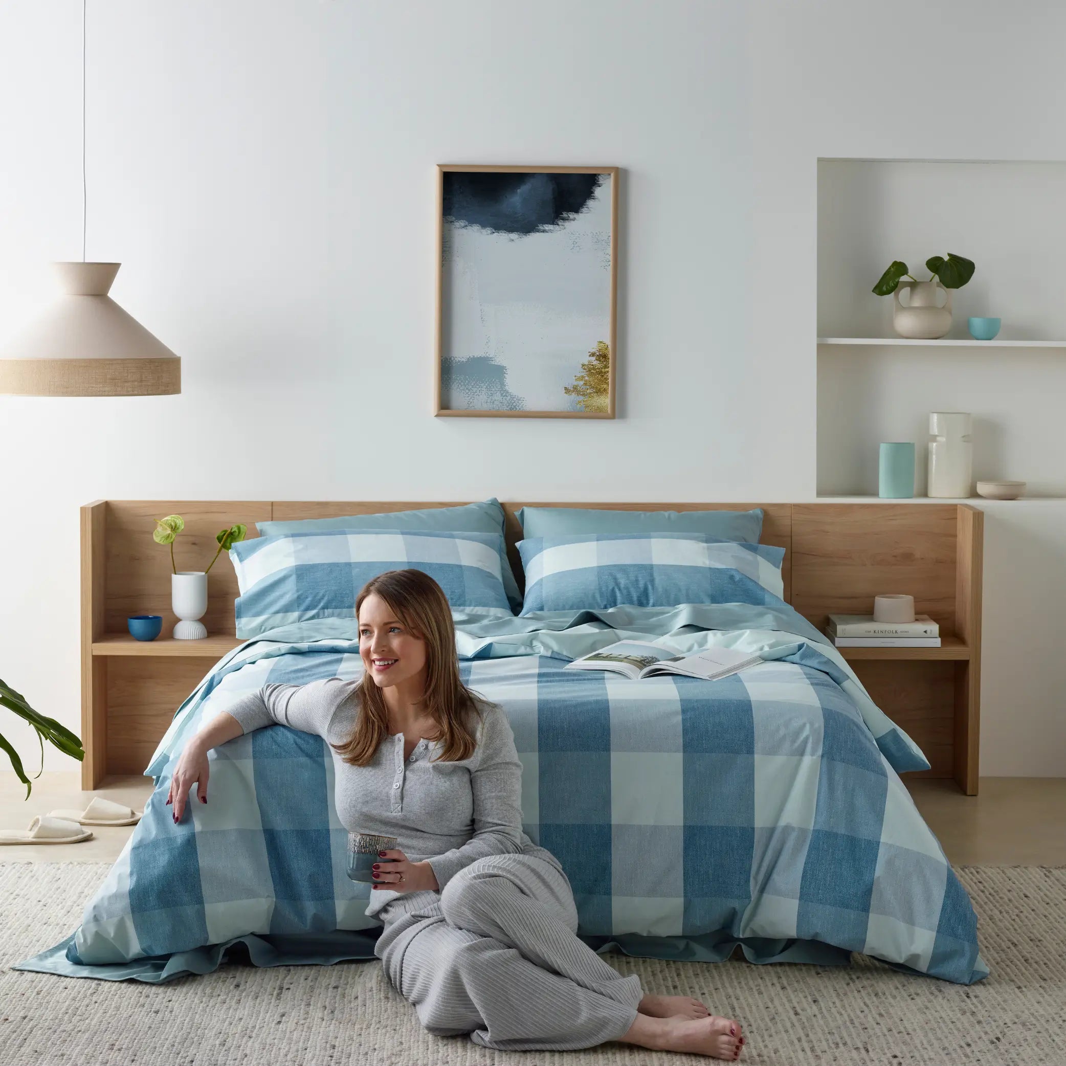 Modern bedroom featuring a blue checkered waterproof quilt cover set with matching pillowcases. Crafted from soft, breathable, and moisture-resistant fabric, this stylish bed linen combines luxury with spill-proof protection.