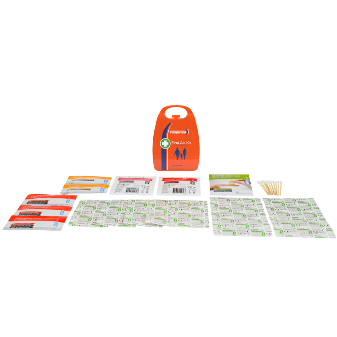 A product image of the Companion 1 Series Plastic Personal First Aid Kit, showing the orange, compact plastic case (with the brand logo and "First Aid Kit" text) surrounded by its contents laid out on a light grey background. The items include assorted plastic plasters, gauze swabs, cleansing wipes, cotton-tipped applicators, and packets of burn gel. This kit is lightweight, small, and designed for minor injuries.