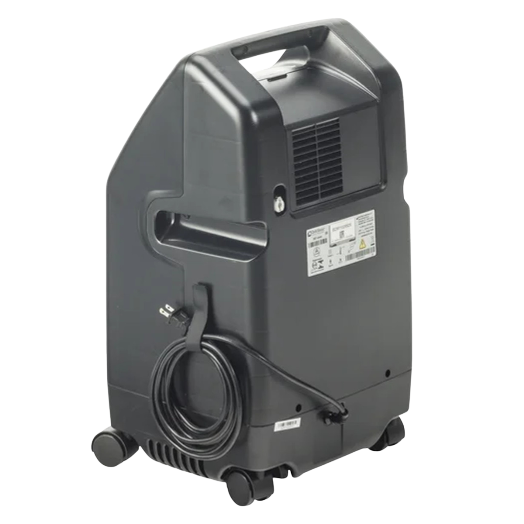 Side and rear view of Drive DeVilbiss Oxygen Concentrator showing power cord storage, ventilation panel, and wheels for easy mobility.
