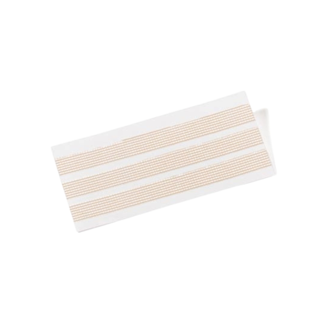 Close-up of three tan Leukostrip sterile wound closure strips with a woven texture, used to hold wound edges together.