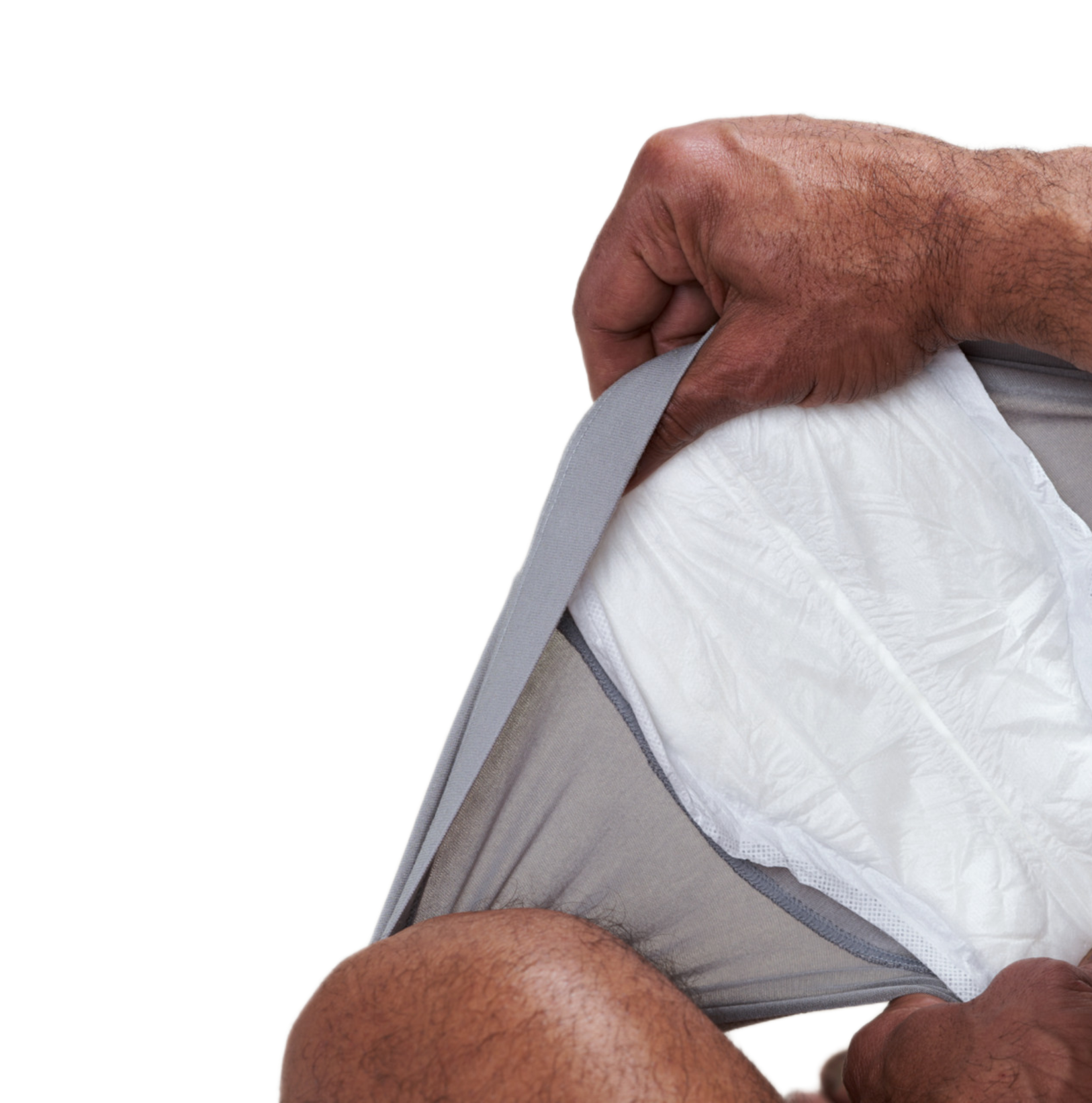 Hand holding a white incontinence pad with gray border against a white background