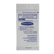 Close-up of a single 30mL Briemarpak 0.9% Sodium Chloride for Irrigation sachet detailing the usage instructions and manufacturer information.