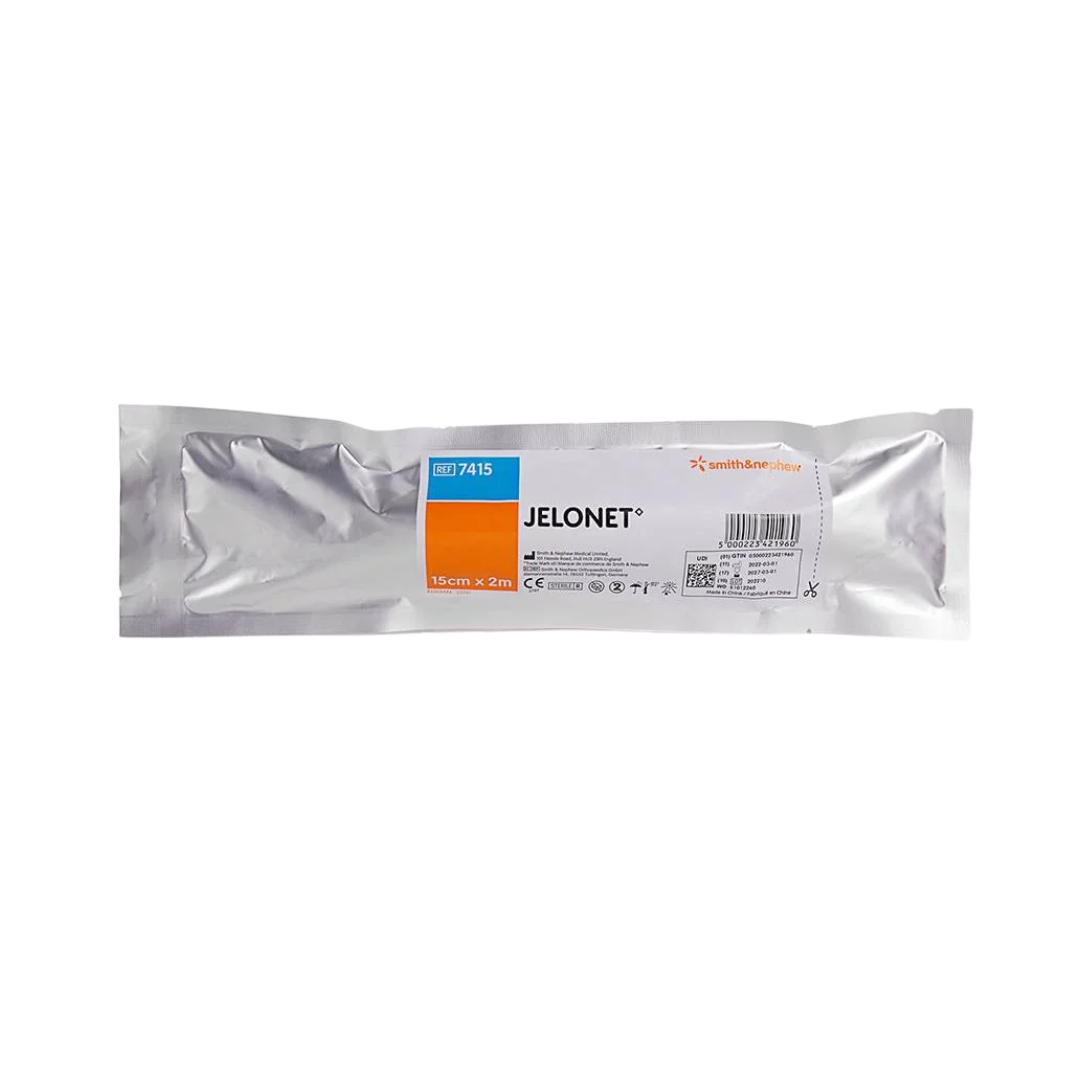 Close-up of the sterile, sealed foil package for the Smith & Nephew Jelonet Paraffin Gauze Dressing, size $15 \text{ cm} \times 2 \text{ m}$.